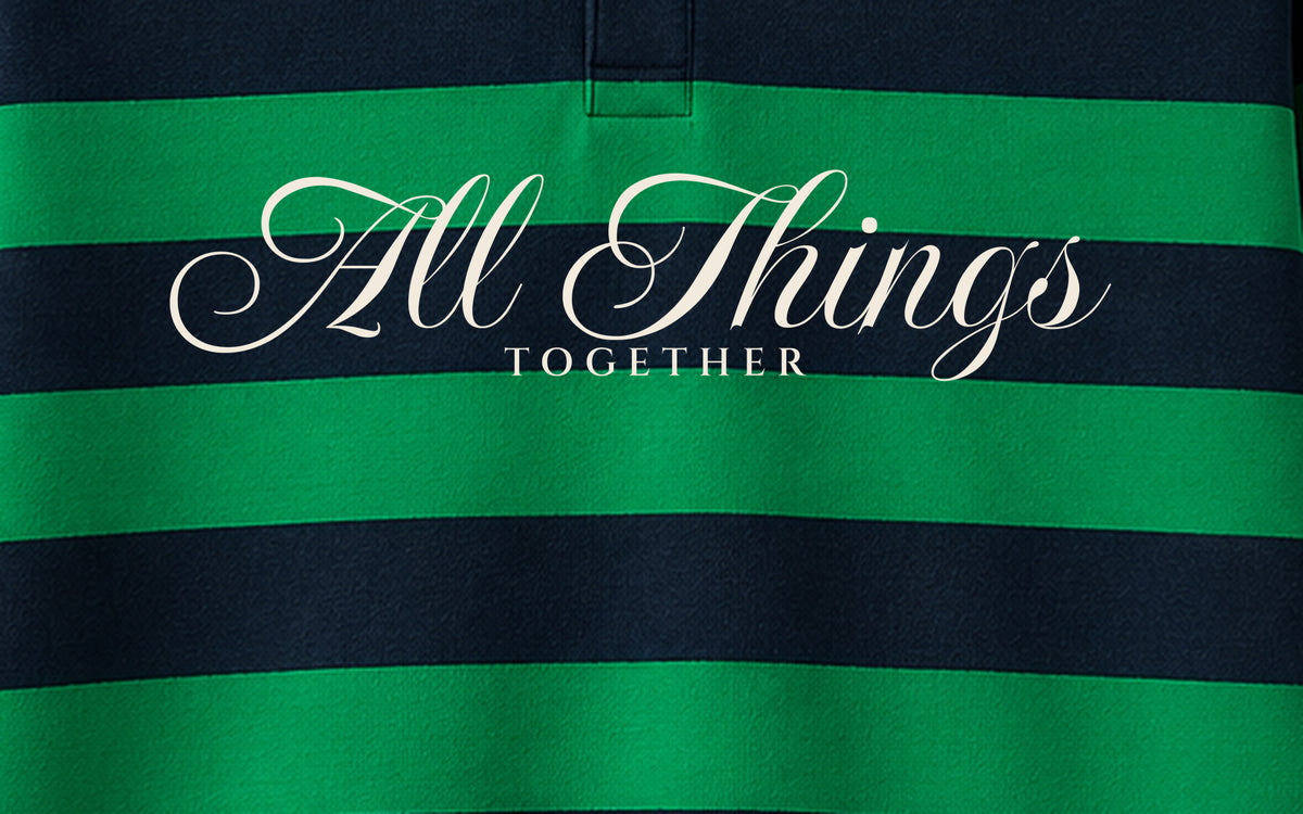 Close-up of ivory ALL THINGS calligraphy with small TOGETHER lettering on green and navy stripes