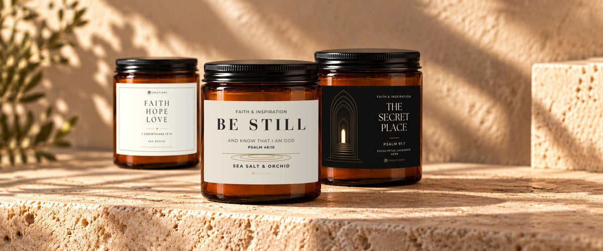 828 Creations faith-inspired amber candles featuring BE STILL, FAITH HOPE LOVE, and THE SECRET PLACE in a warm luxury setting