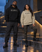 Couple wearing KNOWN. structured heavyweight hoodies in Stone and Black, with clean fronts, no pockets and no drawstrings.