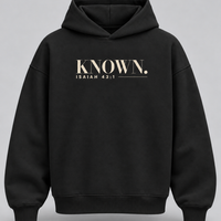 Black KNOWN. structured heavyweight hoodie front with warm ivory Isaiah 43:1 chest artwork, no pockets and no drawstrings.