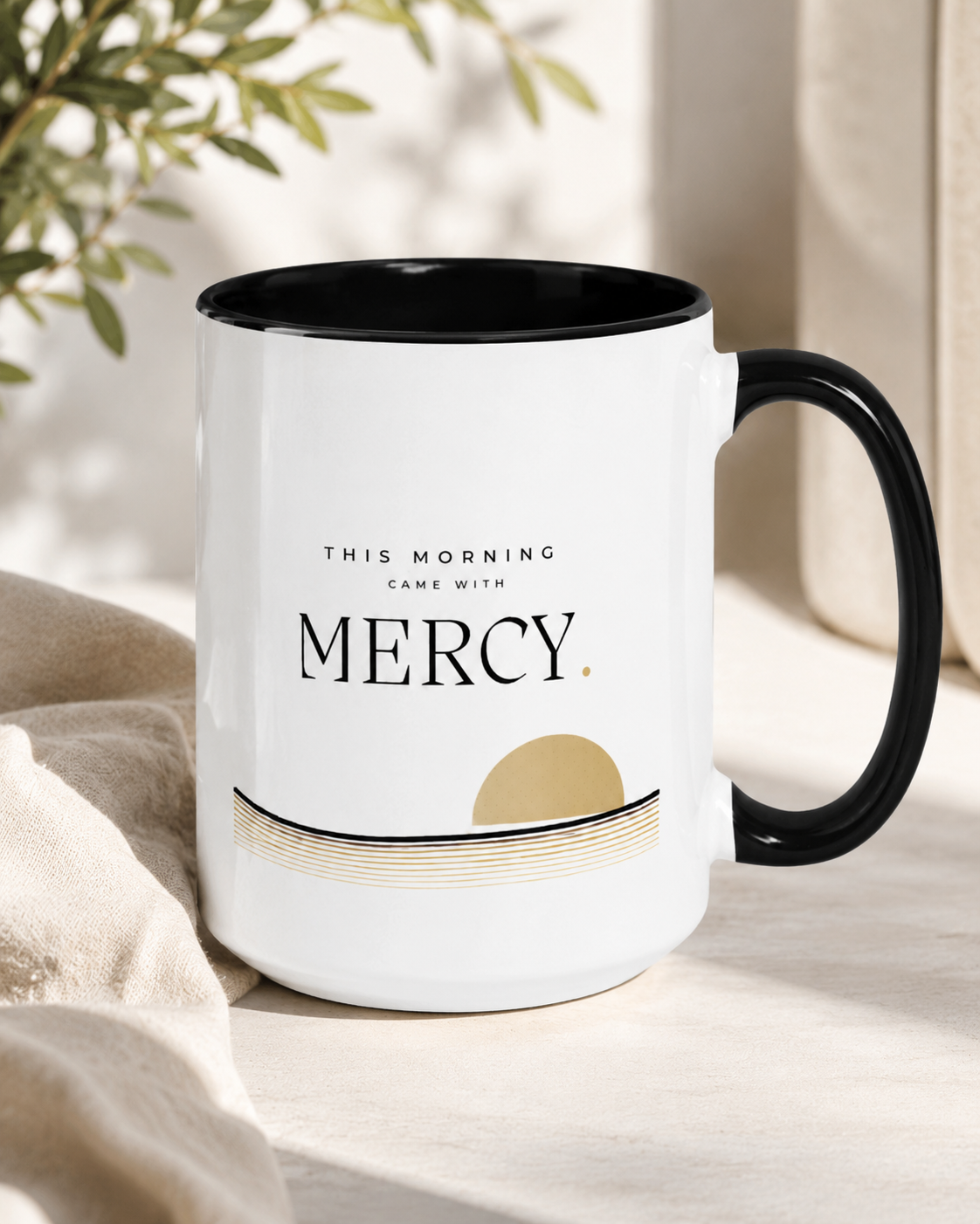 Close-up of Mercy typography and muted gold dawn artwork on Christian ceramic mug