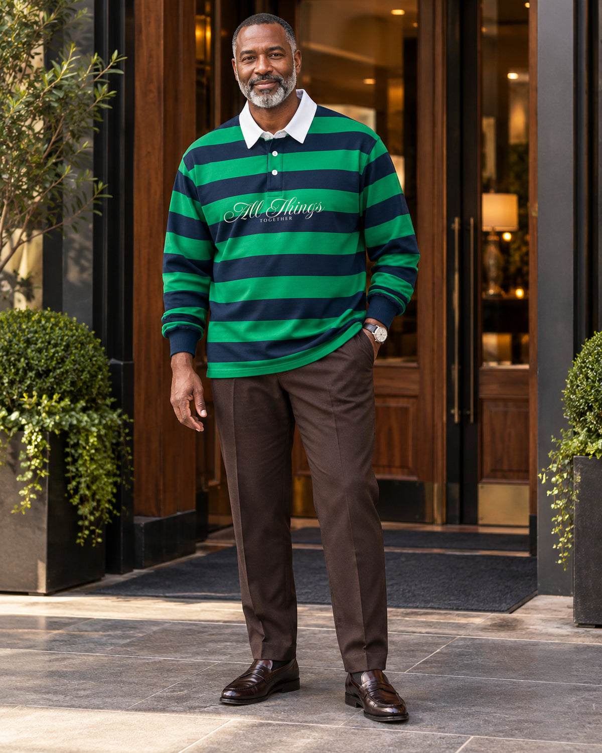 Green and navy rugby polo styled with chocolate tailored trousers and leather loafers