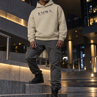 Man wearing the Stone KNOWN. structured heavyweight hoodie with charcoal chest artwork.