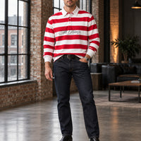 Red and white rugby polo styled with indigo denim and black Chelsea boots in an industrial loft