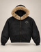 Studio rendering of SET APART sun-faded black boxy zip hoodie with tan faux-fur hood trim and restrained bone left-chest print