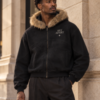 Editorial rendering of a Black male model wearing the SET APART sun-faded black boxy fur hoodie with bone left-chest print