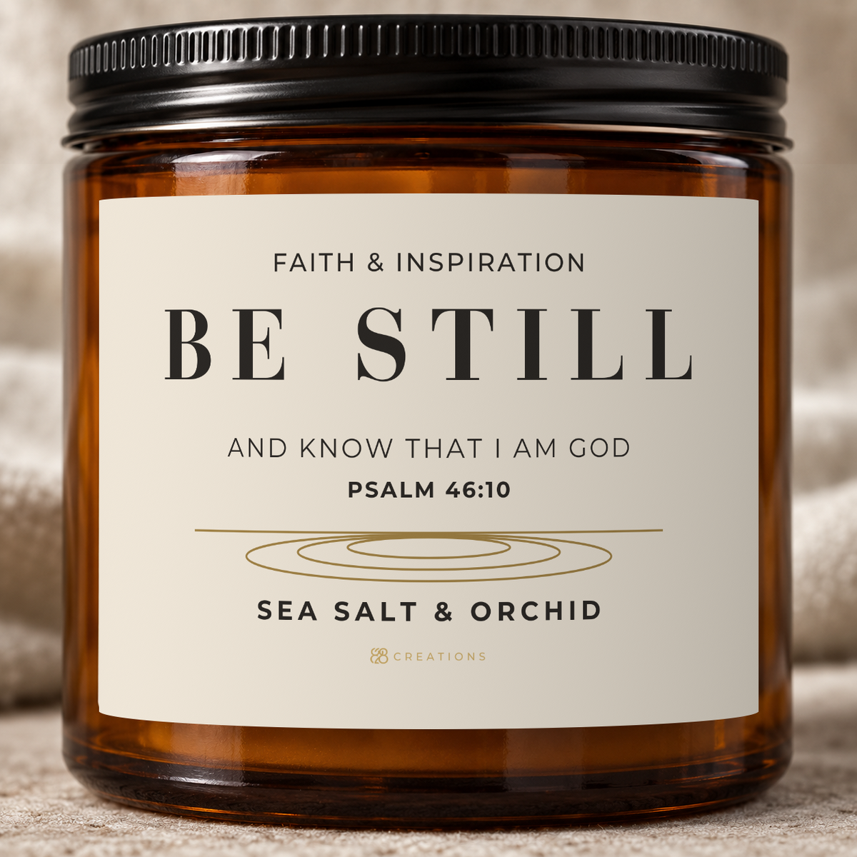 Close-up of the BE STILL Psalm 46:10 label, gold 828 Creations logo and matching ribbed black lid.