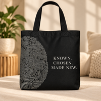 Black Believer Identity large tote with black handles, oversized fingerprint artwork and Known. Chosen. Made New. message