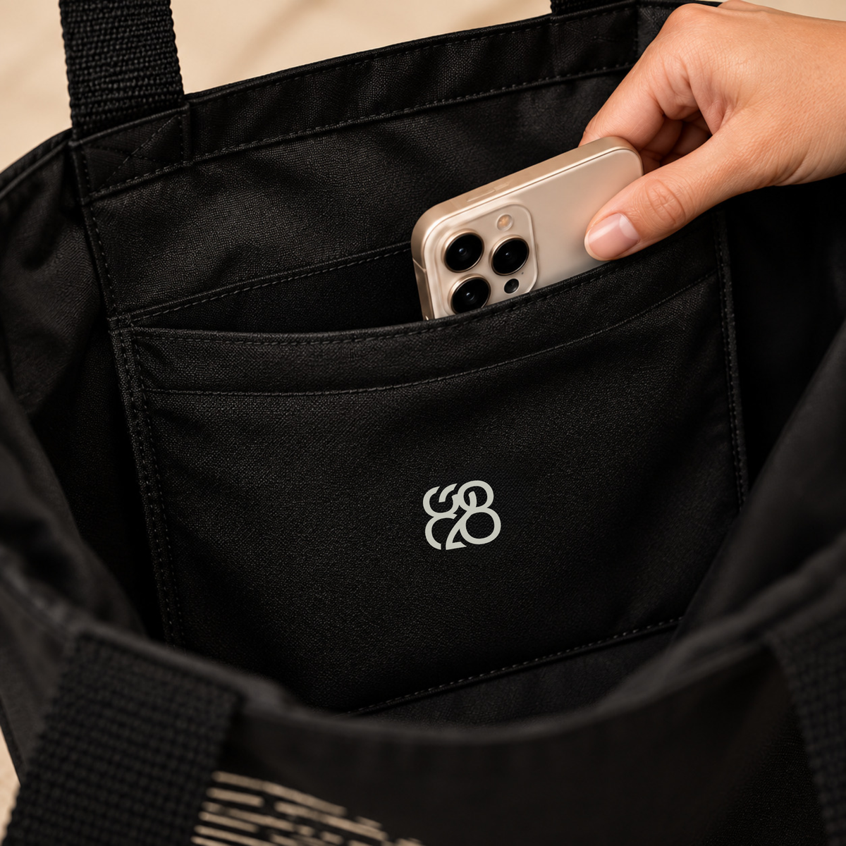 Believer Identity tote inside pocket detail with mobile phone and official 828 CREATIONS brand mark