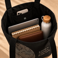 Open Believer Identity large tote showing roomy main compartment with tablet, notebook, wallet, water bottle and inside pocket