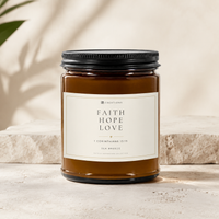 FAITH HOPE LOVE Sea Breeze soy candle in a 9 oz amber glass jar with an ivory Scripture label and matte black lid