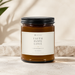 FAITH HOPE LOVE Sea Breeze soy candle in a 9 oz amber glass jar with an ivory Scripture label and matte black lid