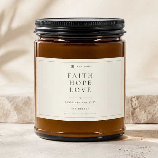 FAITH HOPE LOVE Sea Breeze soy candle in a 9 oz amber glass jar with an ivory Scripture label and matte black lid