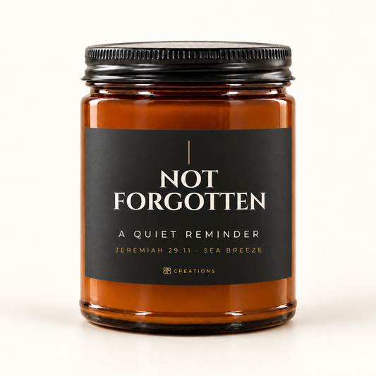 828 Creations NOT FORGOTTEN Charcoal Sea Breeze candle in amber glass with black matte lid and Jeremiah 29:11 · Sea Breeze label.