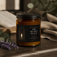 THE SECRET PLACE Eucalyptus Lavender Herb candle with the approved 828 Creations label, styled on wood with linen, eucalyptus, lavender and an open book.