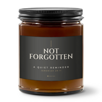 828 Creations NOT FORGOTTEN Jeremiah 29:11 Charcoal candle with the approved smaller title, amber glass, Sea Breeze fragrance and matte black ribbed lid.