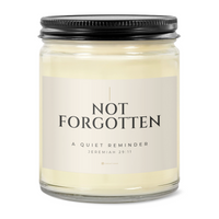 828 Creations NOT FORGOTTEN Jeremiah 29:11 candle in Bone, showing its clear glass jar, Sea Breeze fragrance, and matte black ribbed lid on a white background.