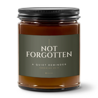 828 Creations NOT FORGOTTEN Jeremiah 29:11 candle in Deep Olive, showing its amber glass jar, Sea Breeze fragrance, and matte black ribbed lid on a white background.