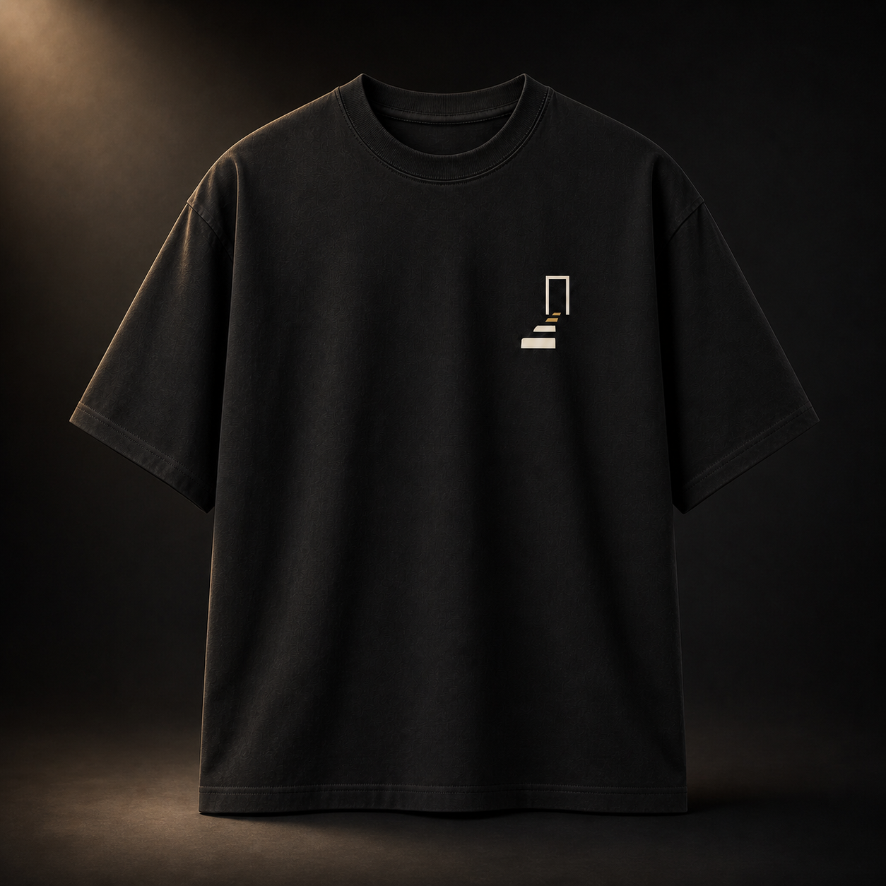 Front of THE REMNANT black oversized heavyweight T-shirt with the minimal Returning Stone chest symbol